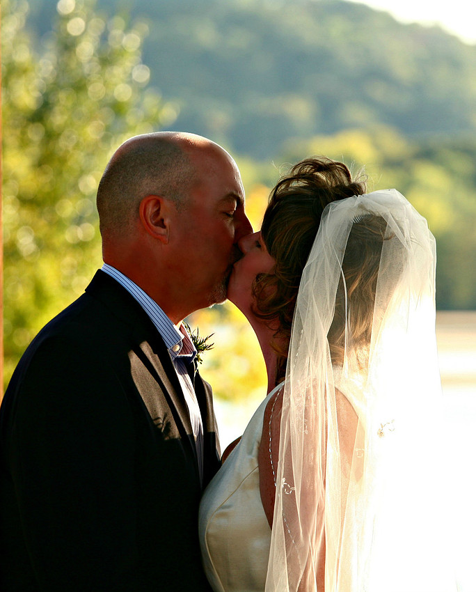 Kiss the bride - beautiful riverside ceremony in Wisconsin