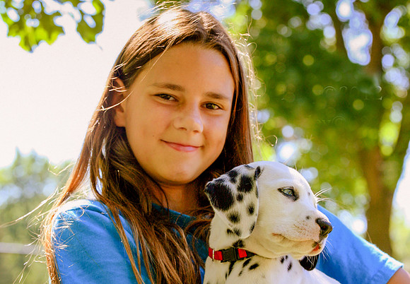 Girl with a Dalmatian Puppy